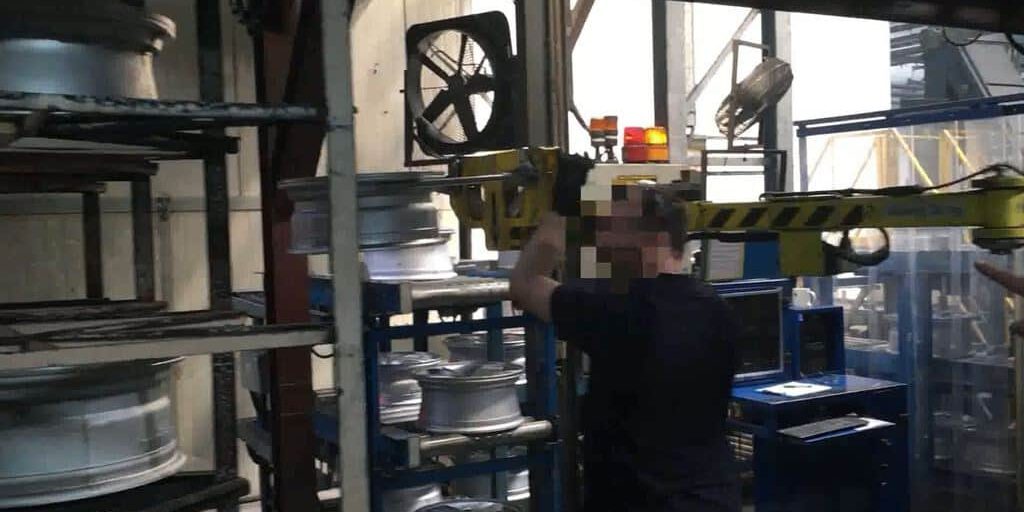 stoccaggio di cerchioni per pneumatici Un manipolatore INDEVA agisce come un'estensione del braccio umano per stoccare i cerchioni dei pneumatici in profondità sugli scaffali.